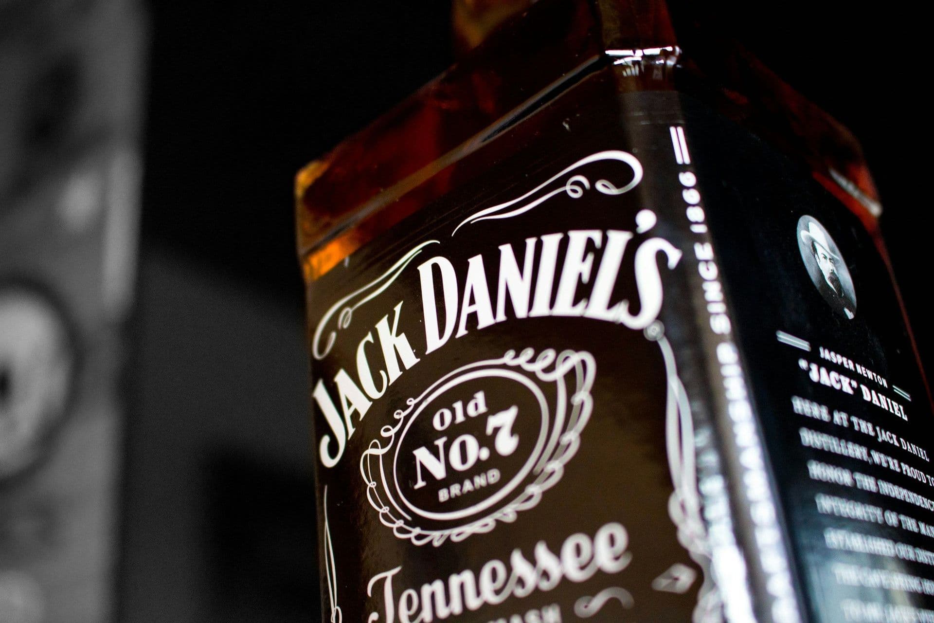 Classic square-shaped Jack Daniel's Old No. 7 whiskey bottle with a distinctive black label, featuring white bold lettering and intricate design.